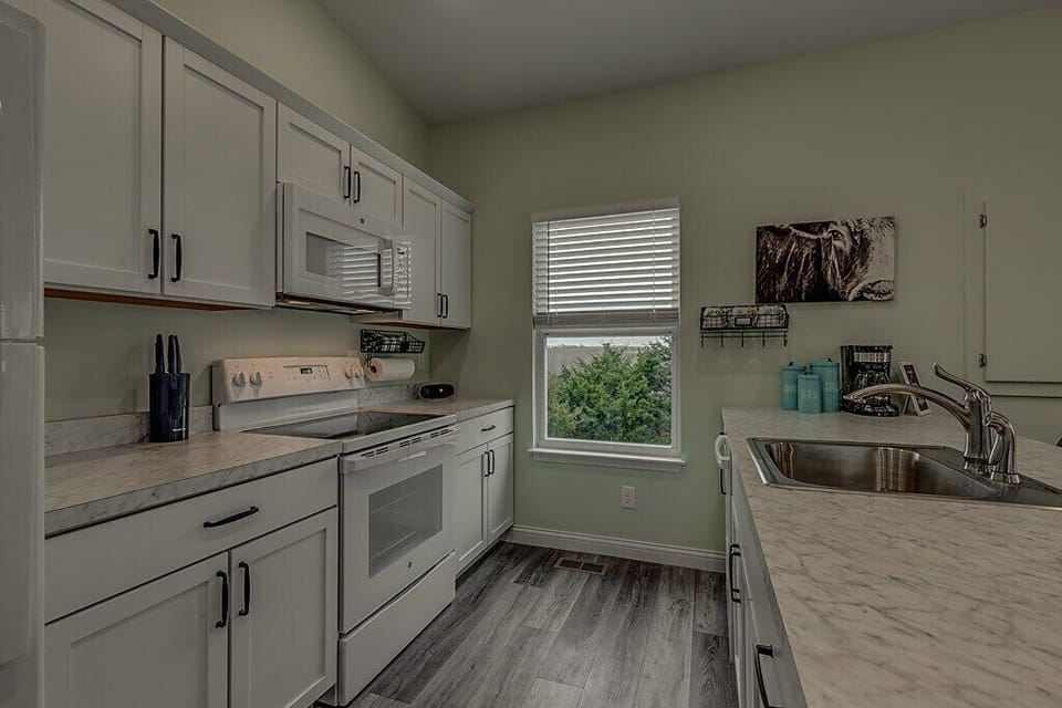 Kitchen includes coffee bar with coffee, sugar, creamer, and tea provided.