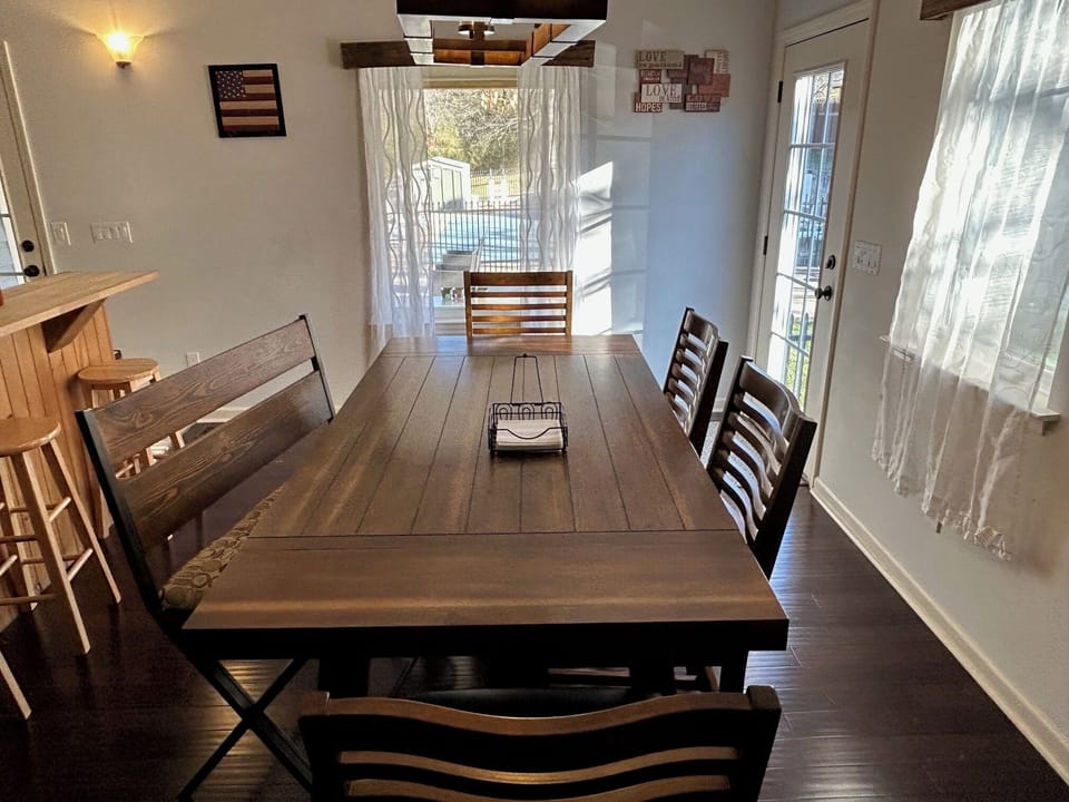 Dining Room table + chairs looking out to Large Pool