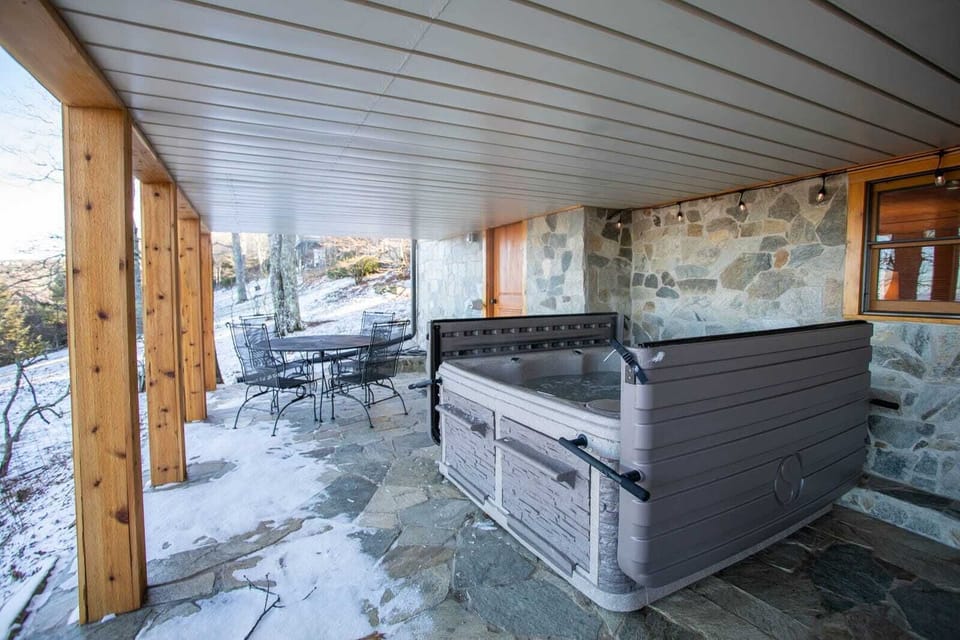 Lower Level Patio from the Game Room has a Hot Tub with an Easy Open Cover and Pull-out Steps