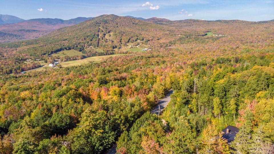 Expansive panoramic deck with unbeatable views of Mt. Washington and Black Mountain. Relax in comfortable seating, dine outdoors, and soak in the fresh mountain air in this stunning retreat.