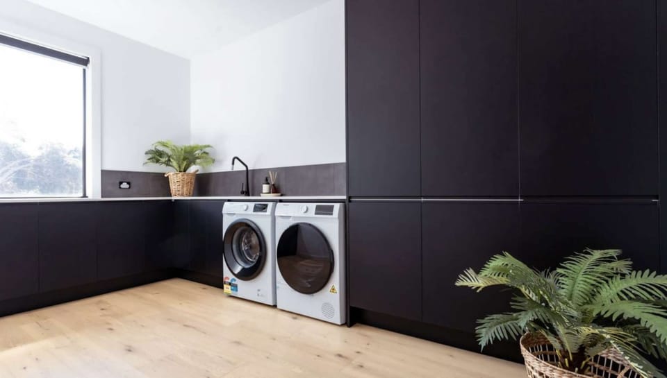 Large laundry with washer, dryer and iron