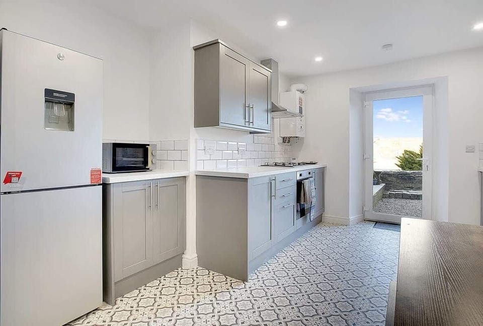 Kitchen equipped with all essentials, including a washer & dryer, oven, fridge, dishwasher and full cookware set.