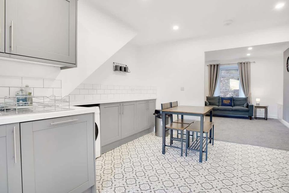 Kitchen equipped with all essentials, including a washer & dryer, oven, fridge, dishwasher and full cookware set.