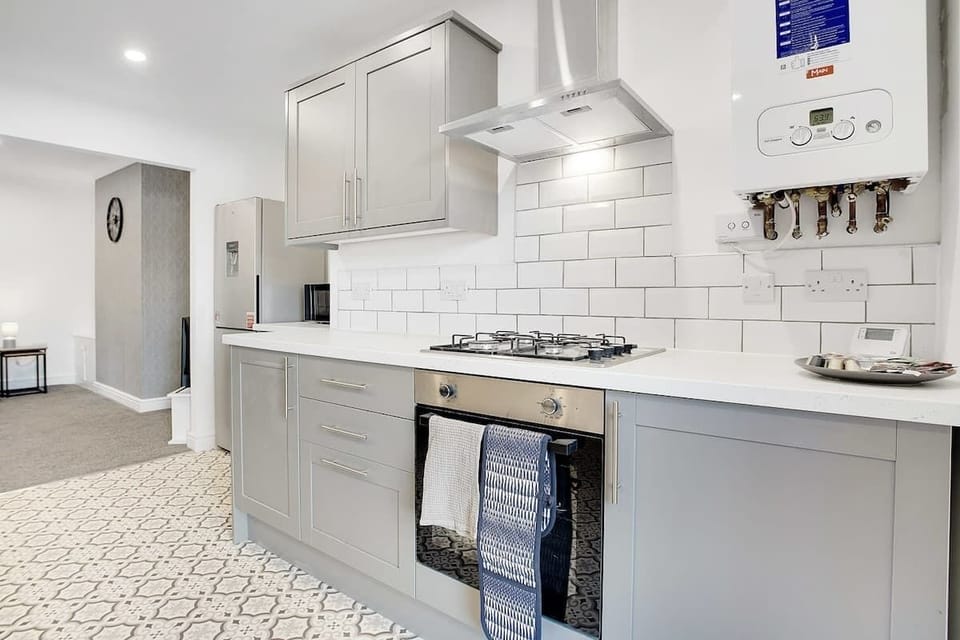 Kitchen equipped with all essentials, including a washer & dryer, oven, fridge, dishwasher and full cookware set.