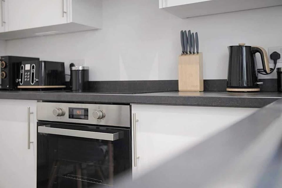 Kitchen oasis equipped with all essentials, including a washer & dryer, oven, fridge and full cookware set.