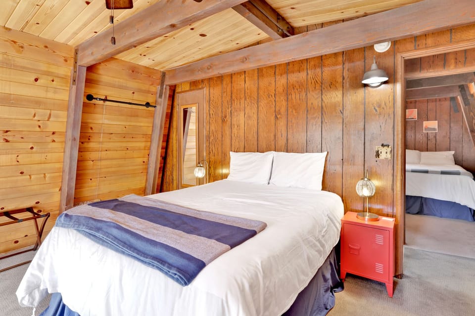 Peaceful cabin bedroom with plush bedding, and beautiful views—ideal for restful nights, cozy mornings, and a relaxing mountain escape.