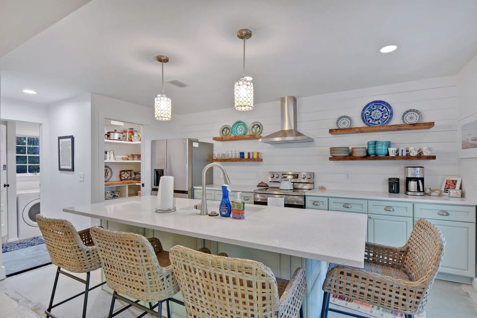Designer Kitchen with Open Shelving - Mint cabinets, wood counters, stainless appliances, and open shelves give the kitchen real character.