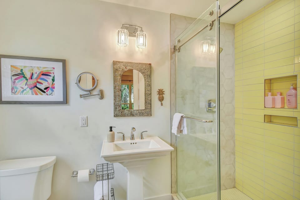Golden Room Attached Bath - Floating vanity, walk-in shower, and aqua walls serve the queen bedroom nearby.
