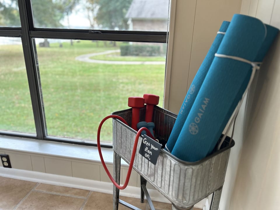 Yoga mats, free weights, resistance bands, & Peloton app for a lakeside workout!