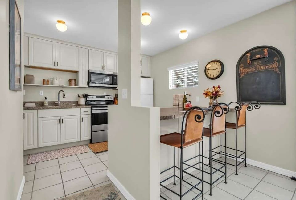 A bright and well-equipped kitchen provides everything you need to prepare delicious meals at home including updating appliances and a kitchen bar.