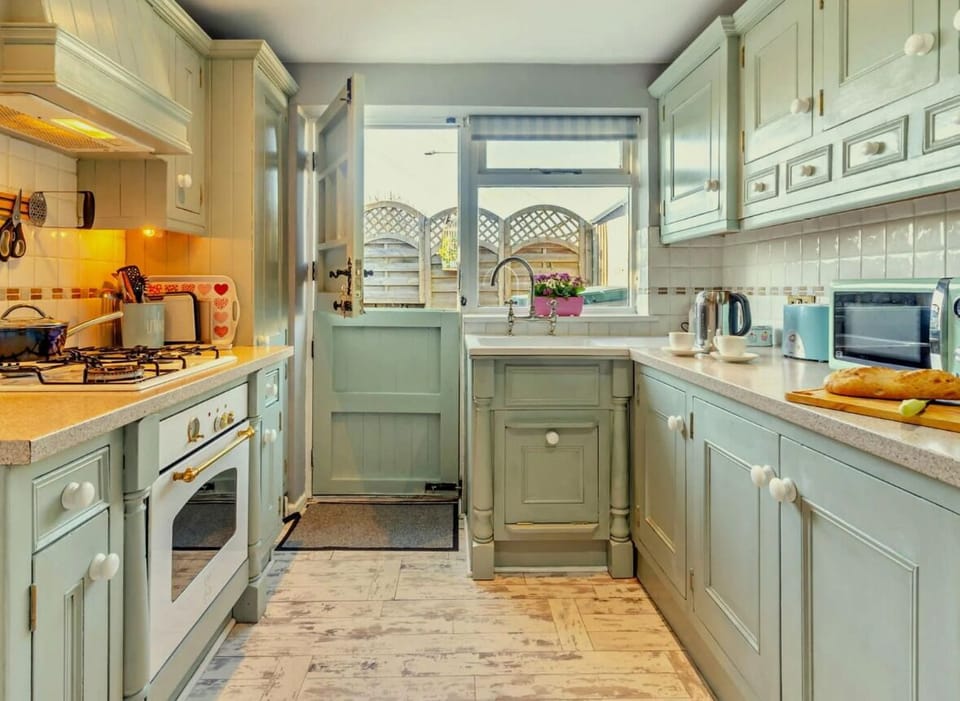 Kitchen. Kettle,microwave, air fryer. fridge freezer, oven. hob. pots and pans.