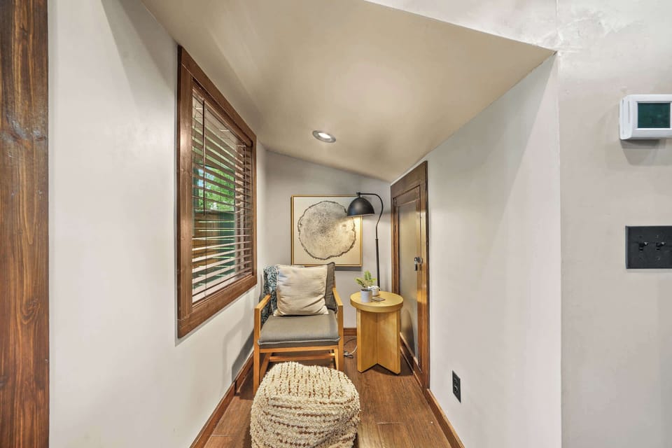 This room also has a cozy sitting nook by the window, perfect for curling up with a good book or just relaxing to enjoy views of nature.