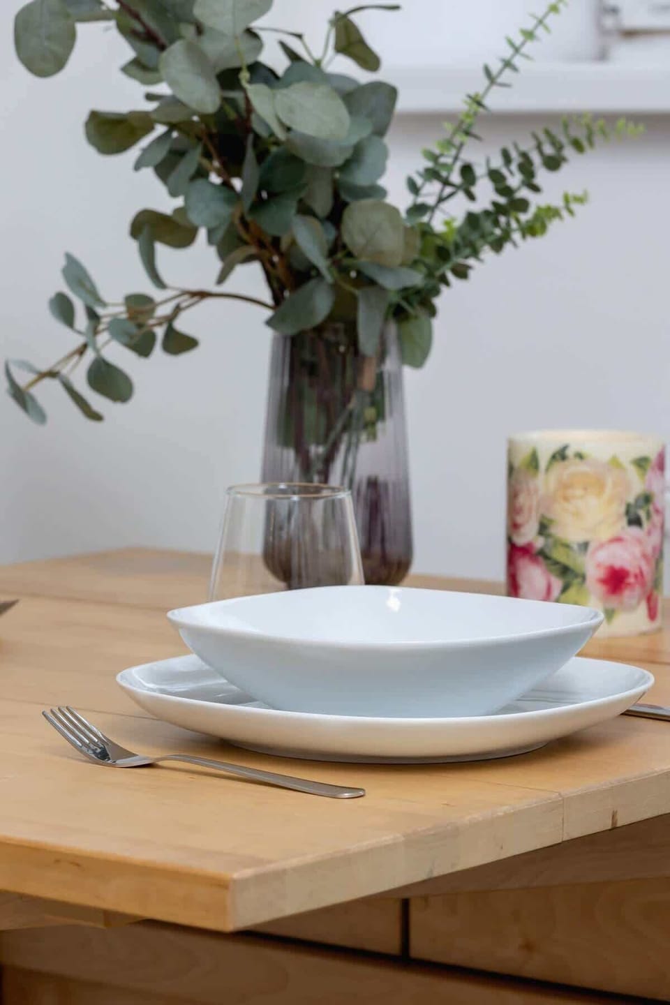 Decorative centerpiece on the dining table with floral arrangements, enhancing the dining experience with a touch of elegance.
