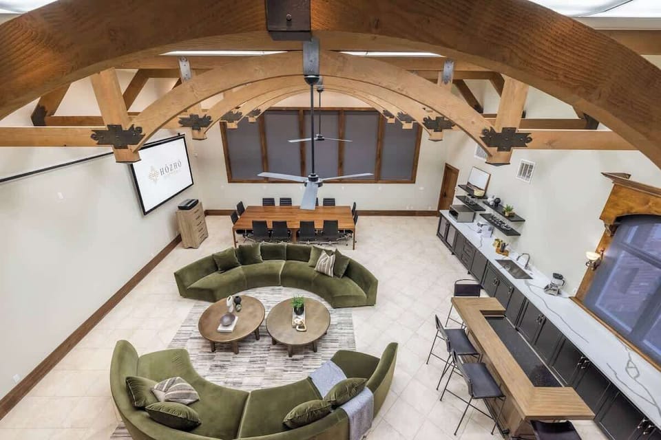 Loft View of Entertainment Hall - Get a bird’s eye view of the entertainment space, highlighting its open design, cozy lounge areas, and stylish bar setup.
