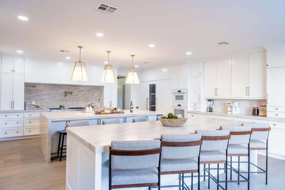 Expansive Kitchen & Dining Space – Elegant lighting and a spacious layout create the perfect place to gather for meals or cocktails before heading outdoors.