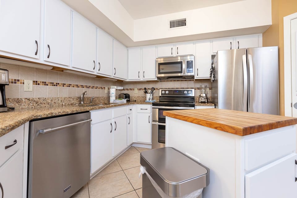 This kitchen features sleek stainless appliances, granite countertops, and a spacious layout perfect for meal preparation