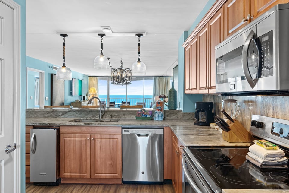 Remodeled Kitchen with granite countertops, stainless appliances - cook delicious meals and dine while overlooking the Gulf of Mexico!