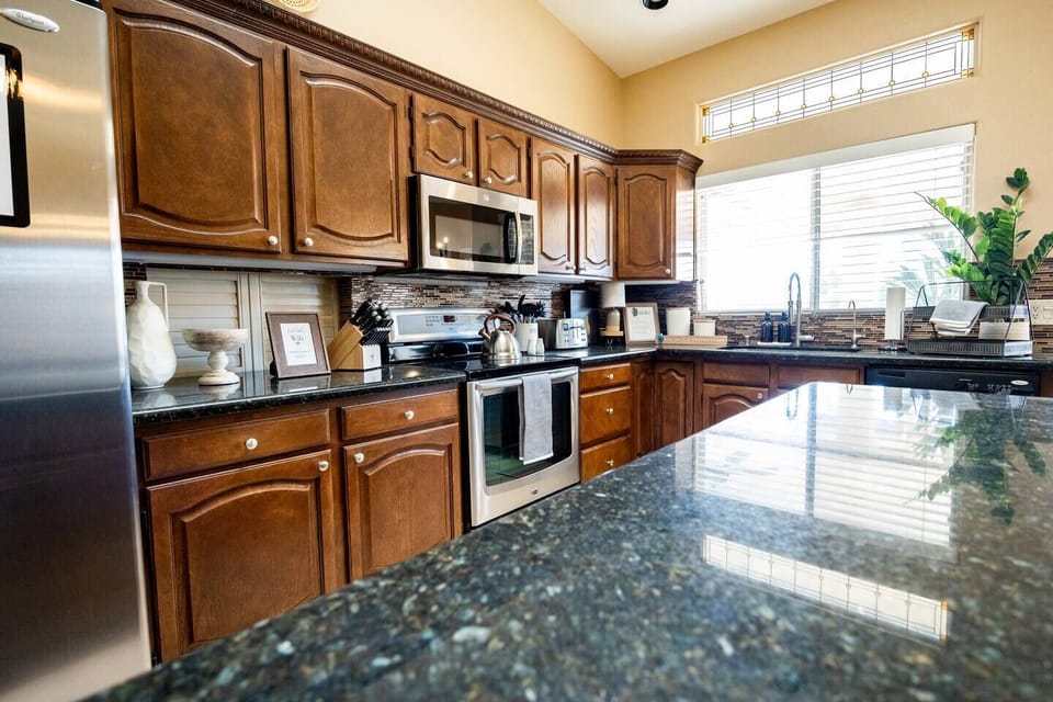 Open concept kitchen with all utensils, pots and pans, and more