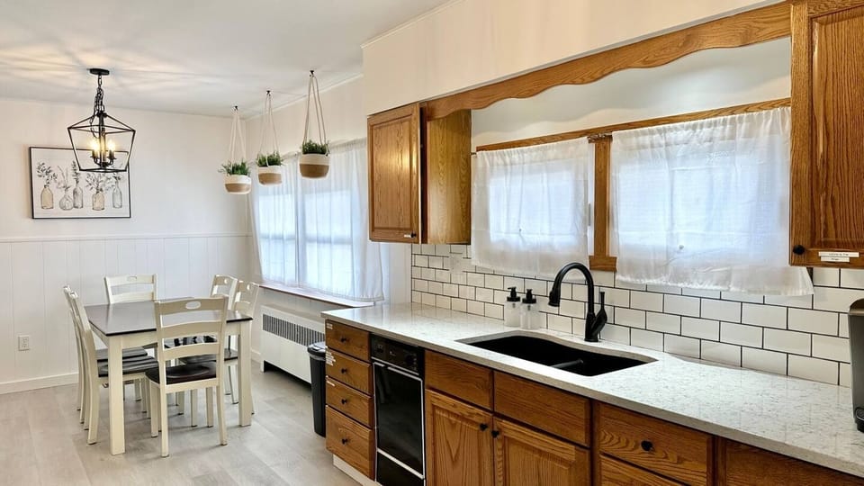 Eat-in kitchen with brand new floors, counters, backsplash, sink and fixtures