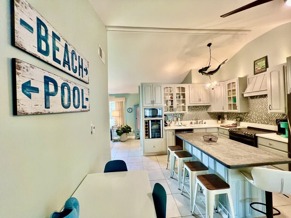 The renovated kitchen has everything you need to fix delicious meals. Distinctive features of the kitchen are quartz counters, a glass backsplash, an island with a food grade finish concrete countertop and a gorgeous mermaid light fixture.