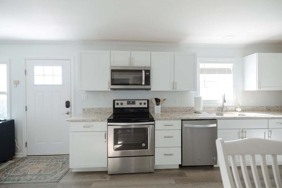Cook with ease in a fully stocked kitchen complete with modern appliances, cookware, dishes, and everything needed for morning coffee or sunset dinners.