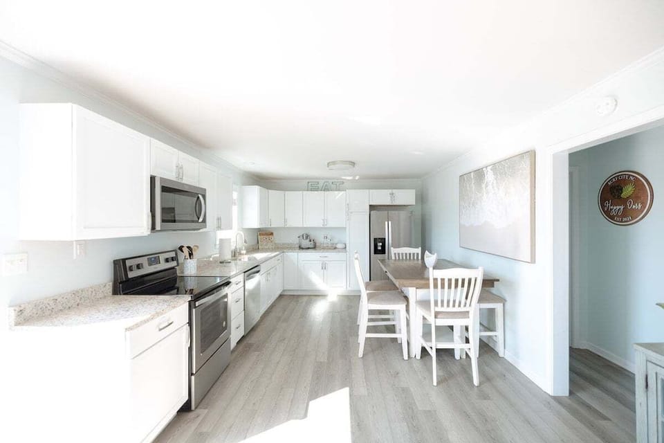 Cook with ease in a fully stocked kitchen complete with modern appliances, cookware, dishes, and everything needed for morning coffee or sunset dinners.