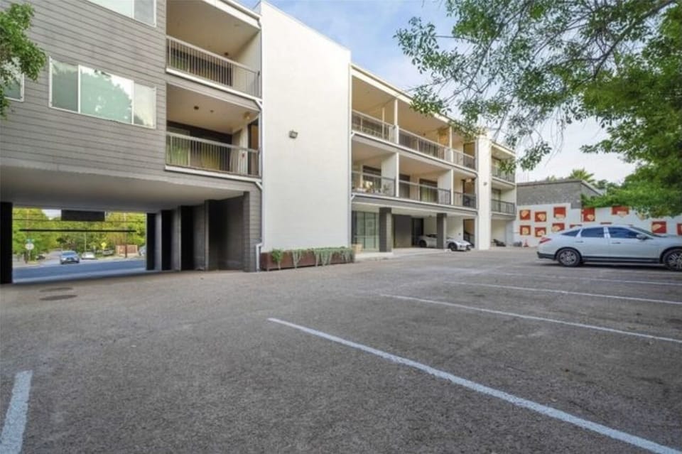 Parking lot of building that includes 1 assigned spot and a pet relief area.