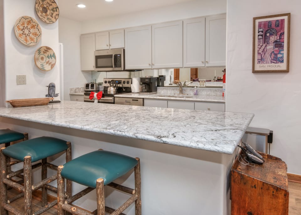 Breakfast bar (seating for three) and fully stocked kitchen