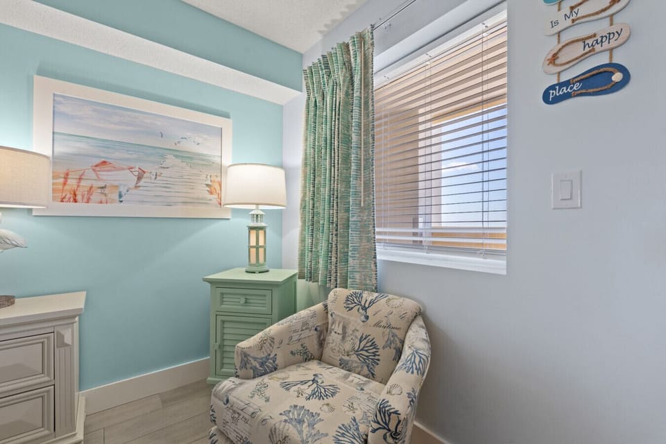 Bedroom features a upholstered chair for relaxing in the evening with a city view of Broadway at the Beach Skyline.  Read, watch your favorite shows, or just unwind away from the family with your own space.