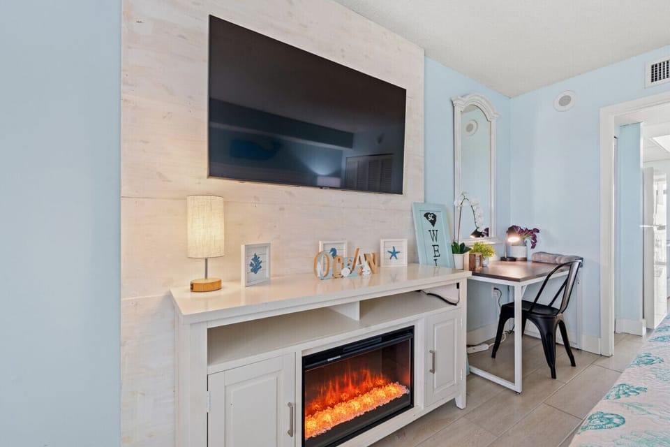 Bedroom also features 50` Smart TV, Indoor Fireplace, and Workspace or Vanity area with Mirror