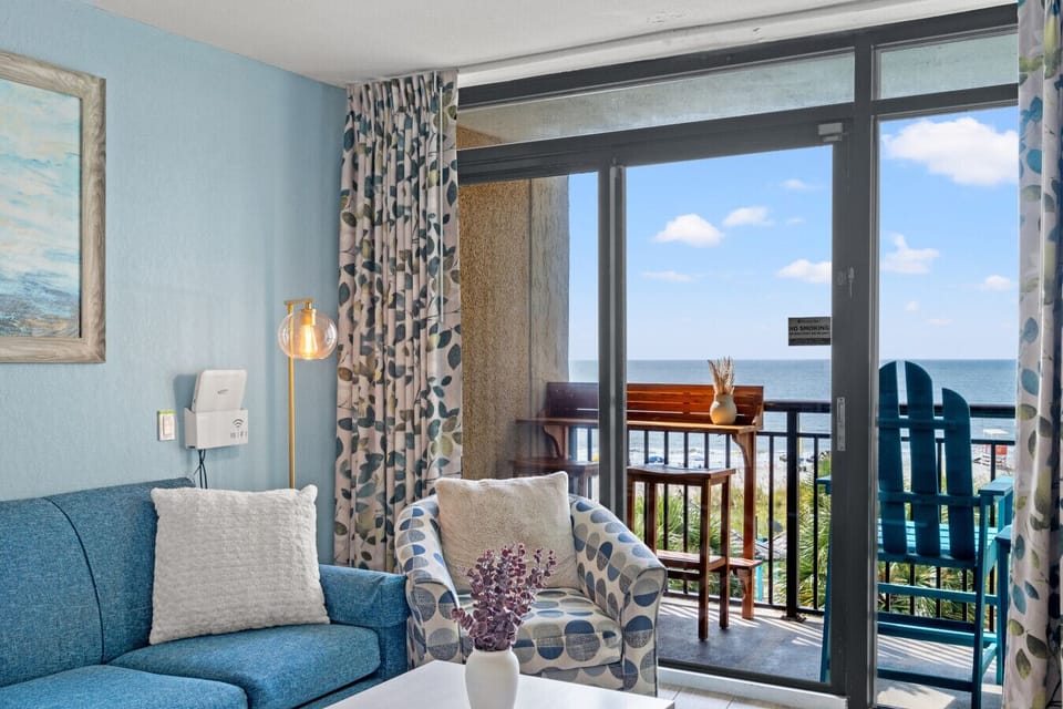 Newly remodeled living room with a stunning oceanfront balcony view, offering a true beachfront experience. Enjoy peaceful beach and resort views from this desirable low-floor condo at Beach Cove Resort, perfect for relaxing and unwinding.