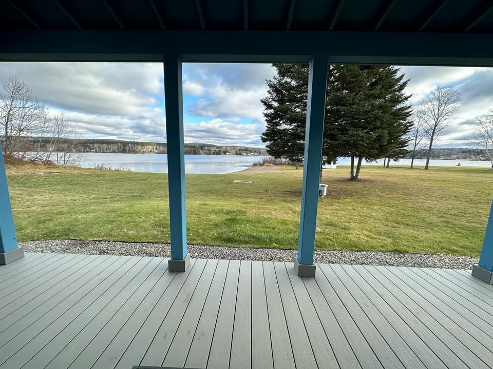 Relax on the porch with stunning lake views, open skies, and serene greenery.