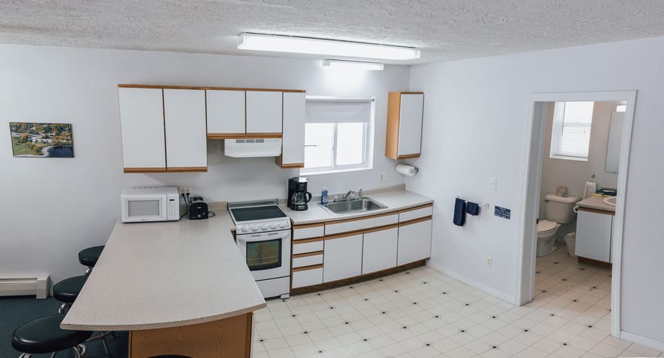 Fully equipped kitchen with a stove, microwave, toaster, and coffee maker
