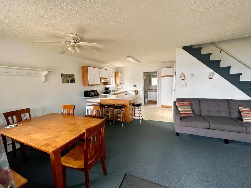 Bright, spacious home with a kitchen, bar stools, dining for six, and sofas