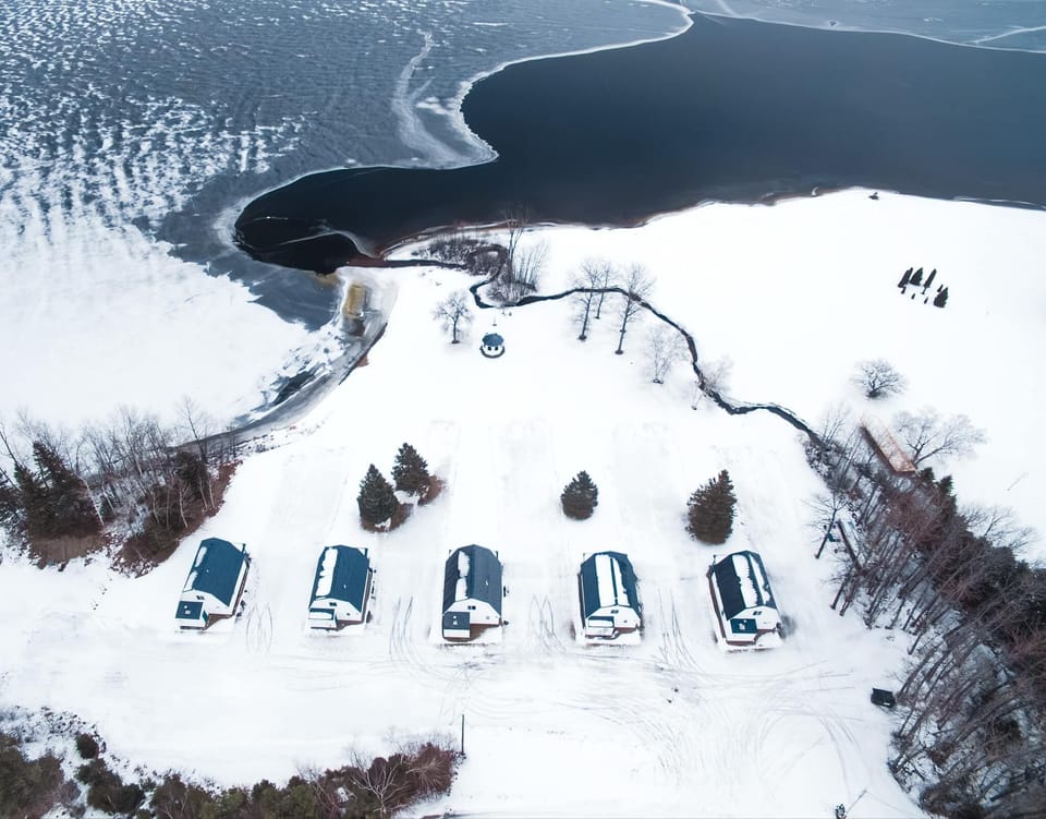 Experience winter at Eagle Lake, where 5 cabins rest under a snow blanket.