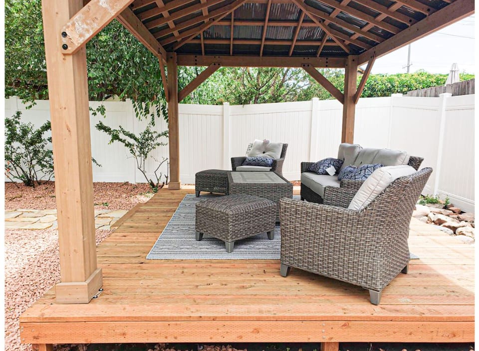 Large gazebo with outdoor seating and fire table.
