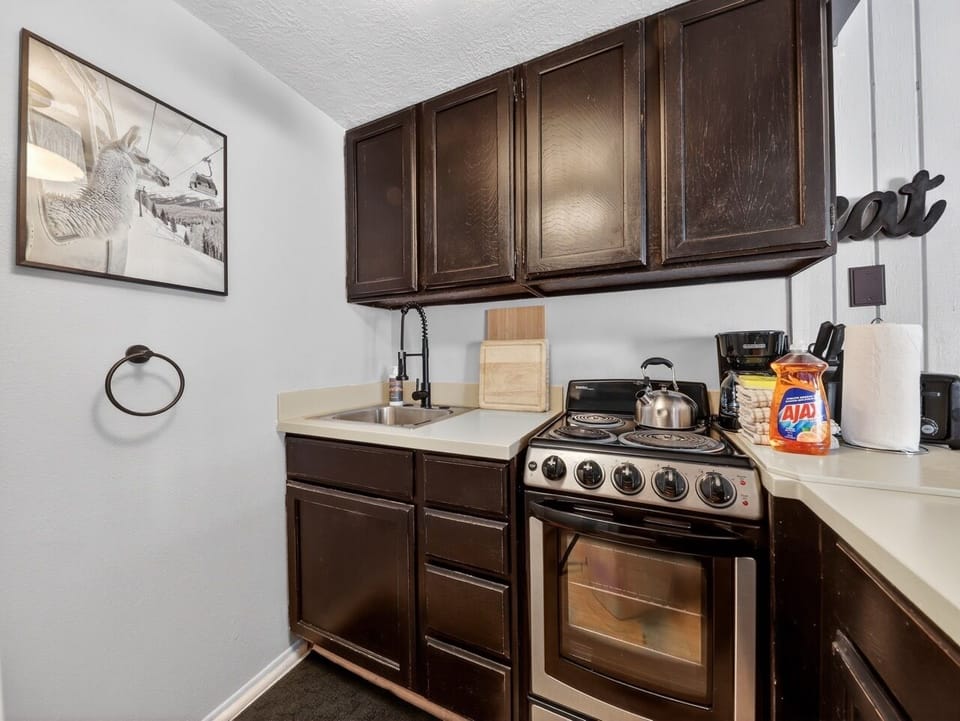 Your fully equipped kitchen features dark wood cabinets, stainless appliances, and everything needed to prepare delicious home-cooked meals during your stay.