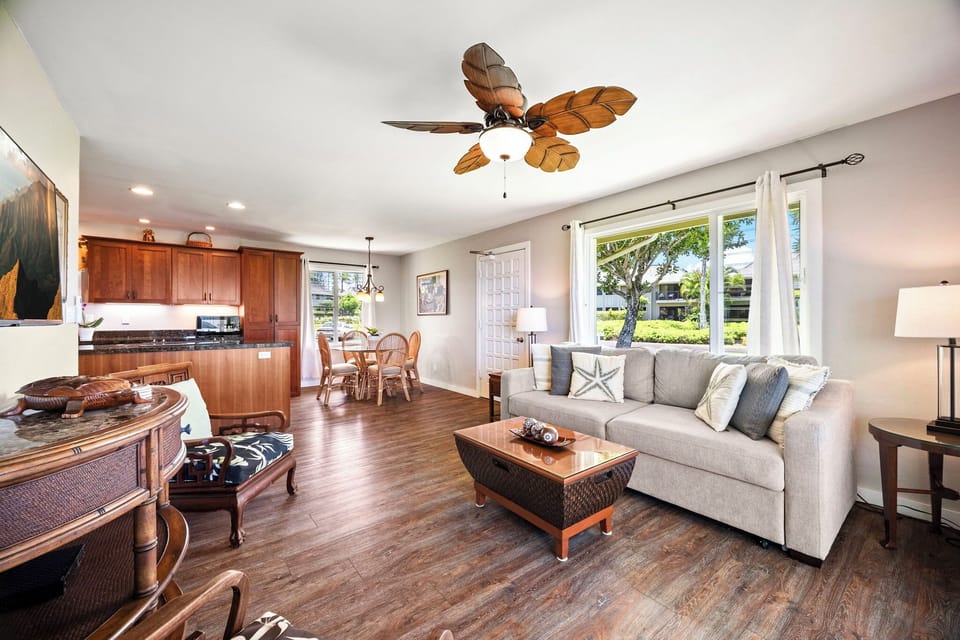 One open room ties the kitchen, dining, and living together under a single fan.