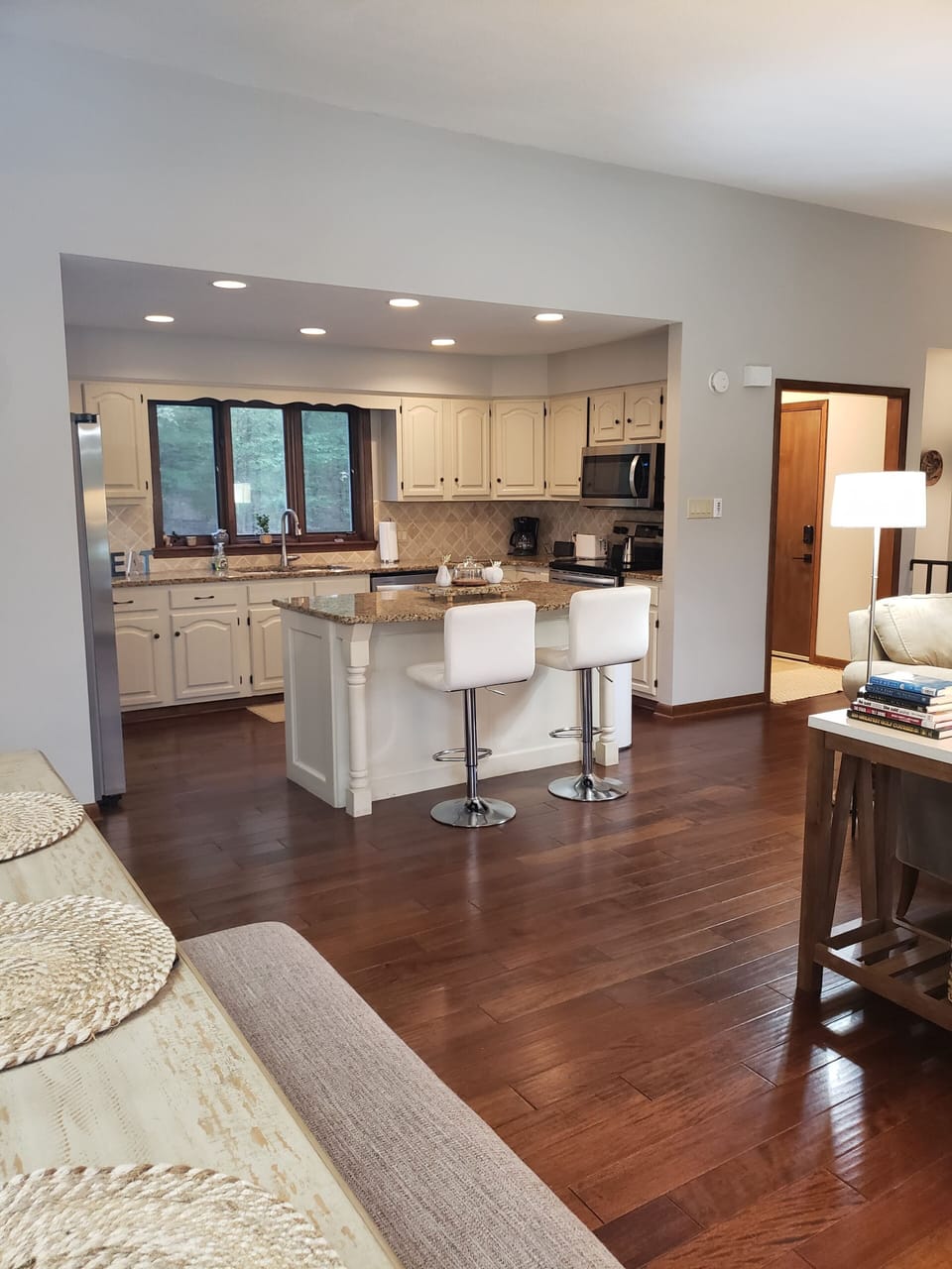 THE KITCHEN ISLAND PROVIDES EXTRA SEATING AND ALLOWS FOR MEAL PREP.