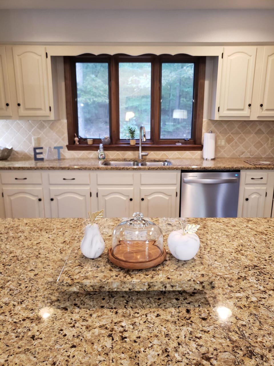 SAVOR A MORNING CUP OF COFFEE AT THE ISLAND, TAKING IN THE FOREST VIEW BEYOND.