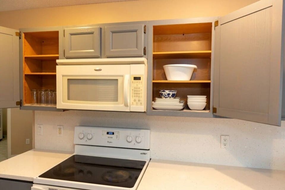 Bright and functional kitchen with open shelving for added convenience.