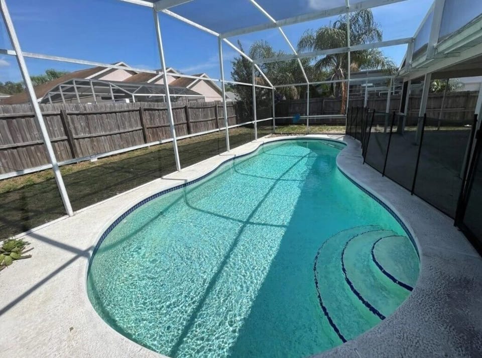Relax by the private screened pool with ample sunshine and privacy.