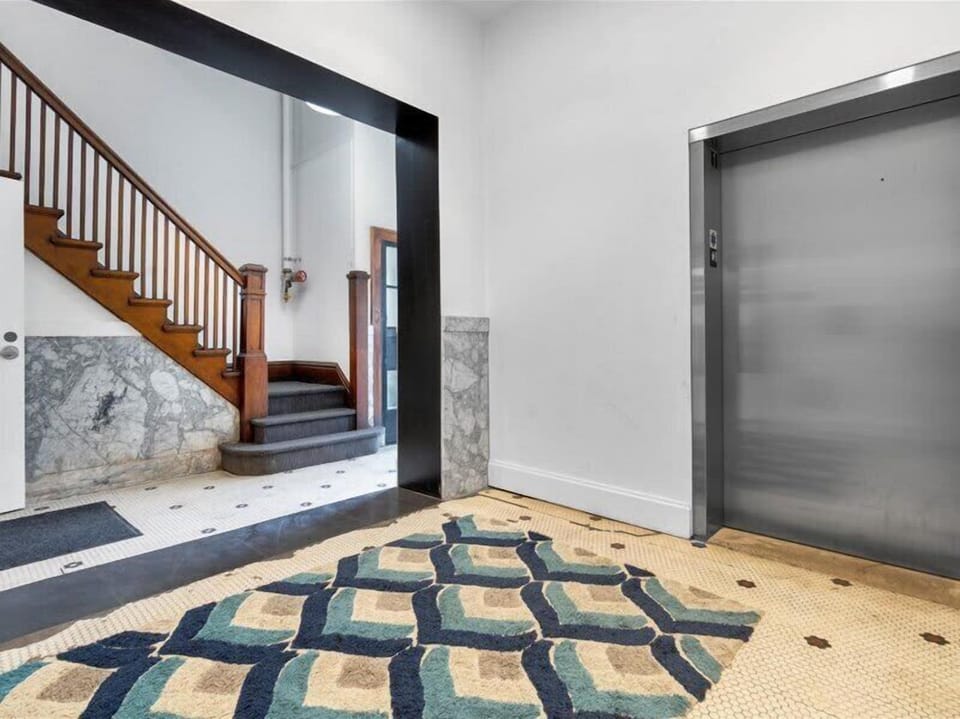 Gorgeous entryway with open staircase and elevator