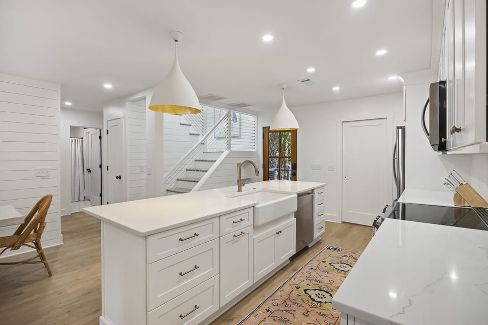 Renovated fully-equipped kitchen with large central island and new appliances, cabinetry and countertops.