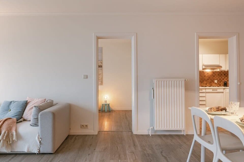 Cozy living room with sofa and direct access to the first bedroom