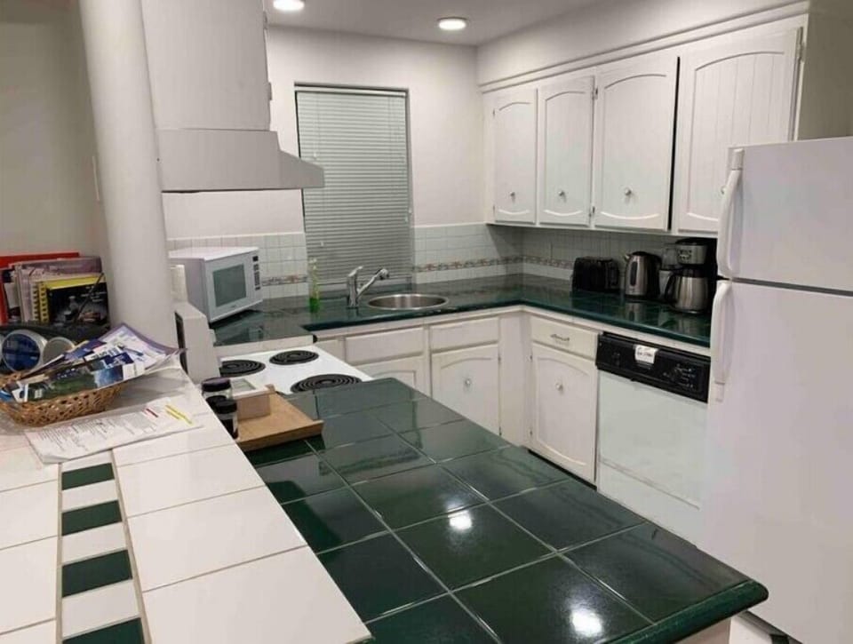 Full kitchen with fridge, stove, microwave, and dishwasher. Pots pans and dishes