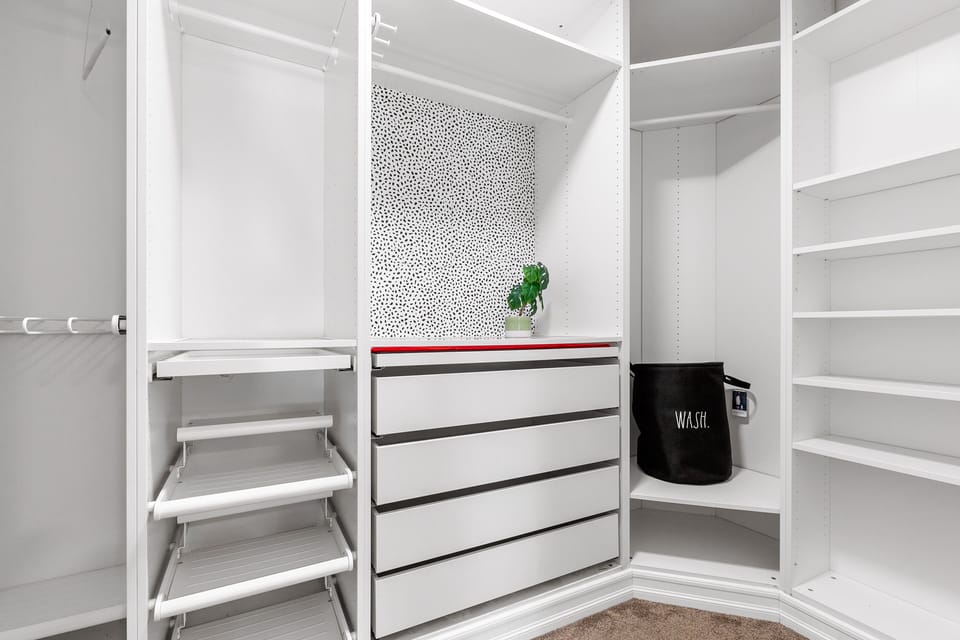 Walk in closet with shelves and drawers in the  guest bedroom
