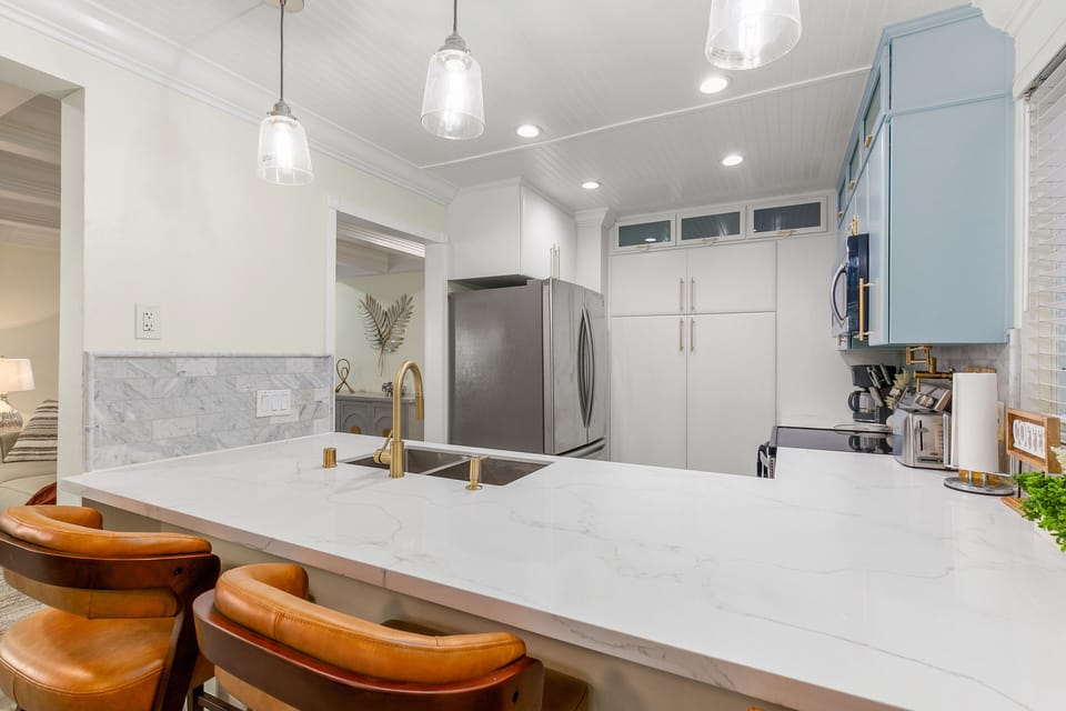 Beautiful quartz counters and gold fixtures