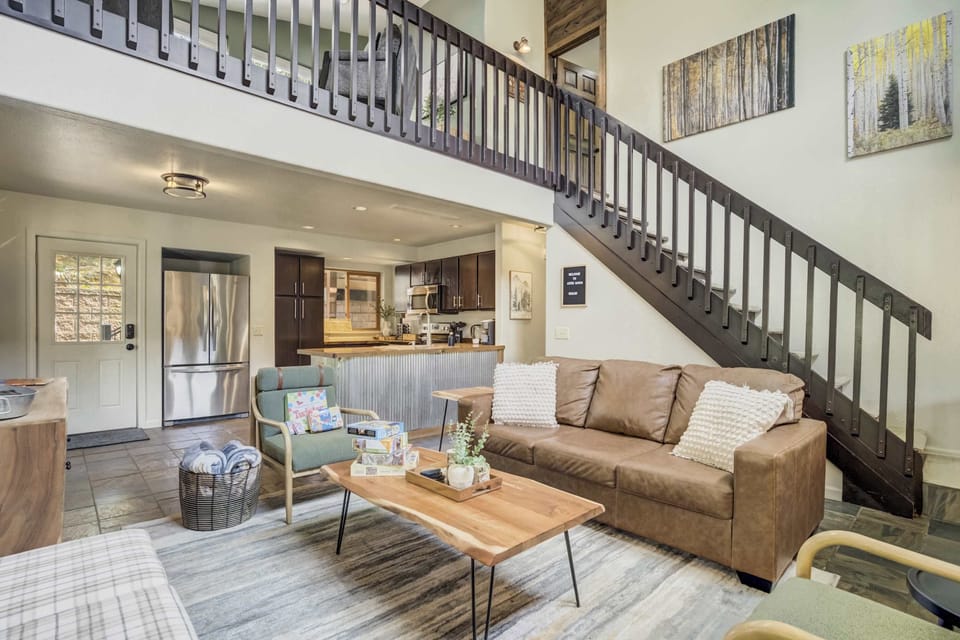 Sink into comfort with a cozy sofa and chairs in our living room, conveniently located close to the kitchen for a seamless and enjoyable living space.