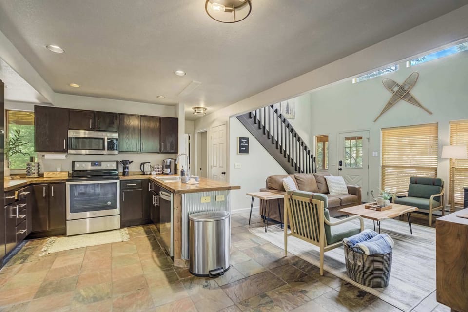 Enjoy open-concept living with a fully stocked kitchen and cozy lounge—perfect for group meals, morning coffee, or relaxing after a day of adventure.

